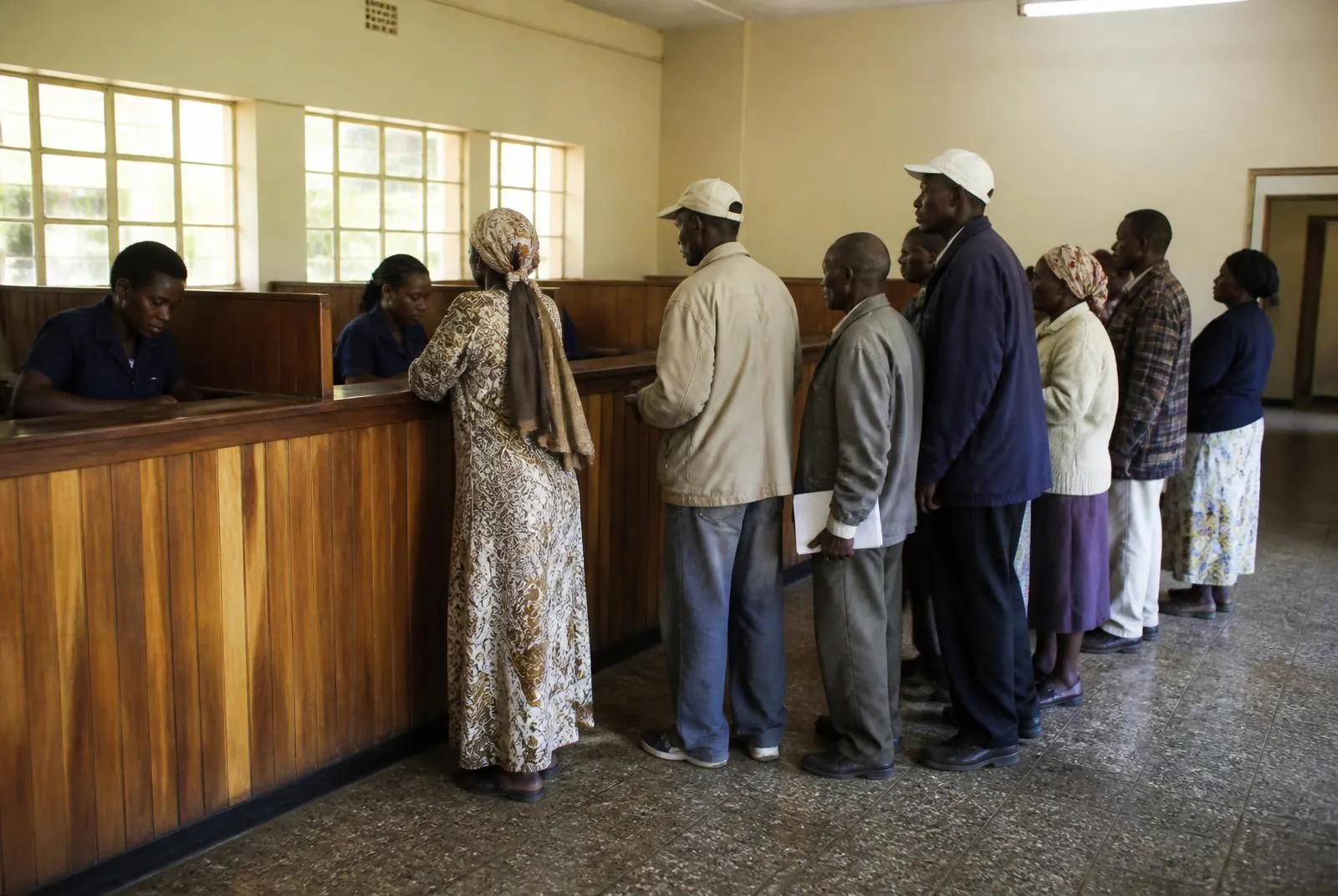 Members being served at the counter in a TAI DT Sacco branch banking hall